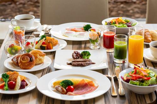a table topped with plates of food and drinks at ANA Crowne Plaza Hiroshima by IHG in Hiroshima
