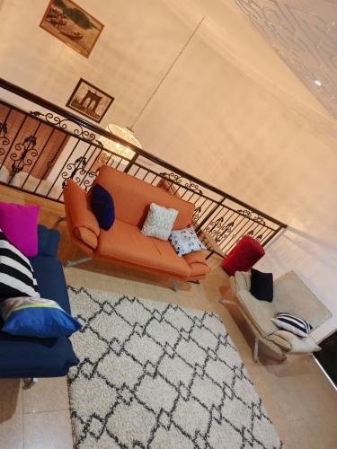 an overhead view of a living room with a couch and chairs at TheGeneral Place in Ikorodu