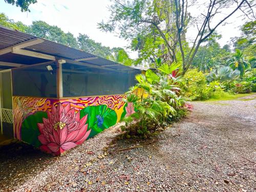 a building with a painting on the side of it at Ita Ita Casitas Playa Punta Uva in Punta Uva
