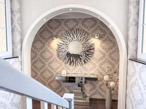 a hallway with a staircase with a mirror on the wall at WILD&COZY Ferienhaus mit 160m2, Garage und 2 Bäder in Blankenburg