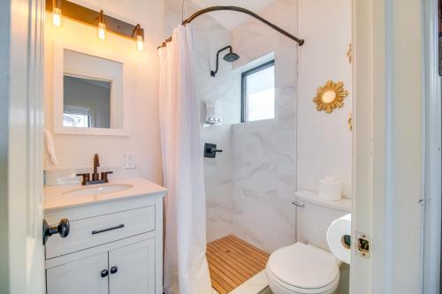 a white bathroom with a toilet and a sink at Deck and Boat Dock Lakefront Cabin in Eucha! in Eucha