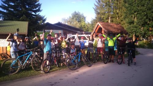 a group of people posing for a picture with their bikes at Apartment Beli Zajec in Mozirje