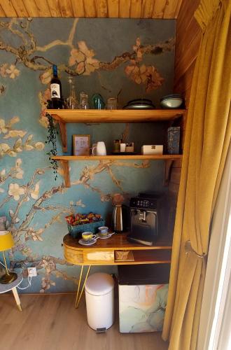 a room with a table and a wall with a wallpaper at Het baken van Tholen met Wellness en Theetuin in Sint Maartensdijk