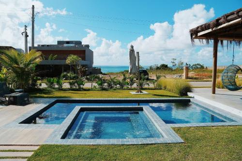 a swimming pool with a view of the ocean at Casa Vista Mar, Piscina Aquecida/Hidro, Cozinheira in Barra do Camaragibe