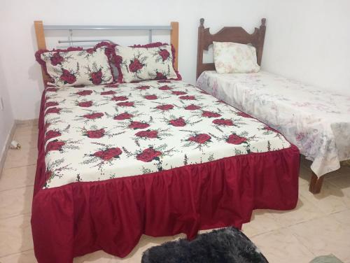a bedroom with a bed with a comforter at Bella casa de praia in Araruama