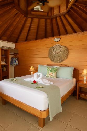 a bedroom with a bed with a swan on it at Exclusive Sunrise Boutique Resort & Private Island- Adults Only - All Inclusive Intimate Island & Santo Experience for Only 9 Couples at a Time in Saraotou