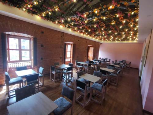 an empty restaurant with tables and chairs and lights at Hotel Casa Santiago in Estación El Salto
