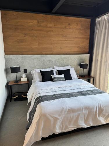 a bedroom with a large bed with a wooden headboard at Upscale 2BR 2BA Apt w incredible Mountain Views in Oaxaca City