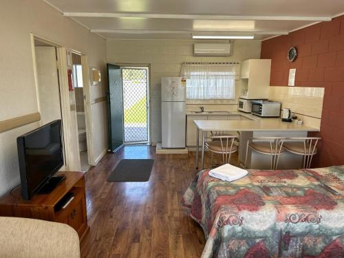 a room with a kitchen and a living room at Coral Tree Lodge in Greenwell Point
