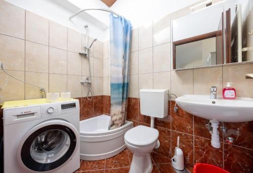 a bathroom with a washing machine and a sink at Apartments by the sea Igrane, Makarska - 311 in Igrane