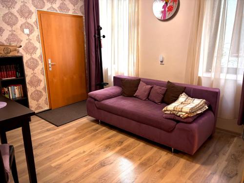 a purple couch sitting in a living room at Ultracentral Apartment 2 in Braşov