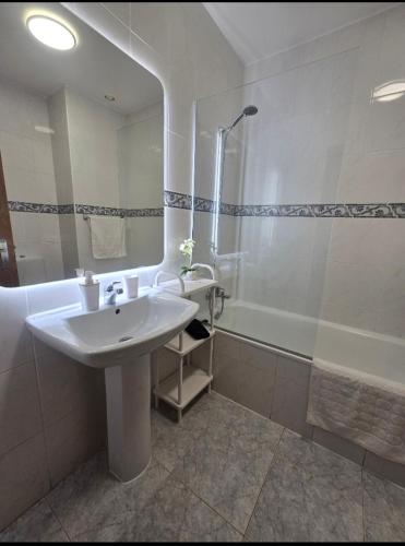a bathroom with a sink and a shower and a tub at Ocean Pearl Apartment W in Funchal