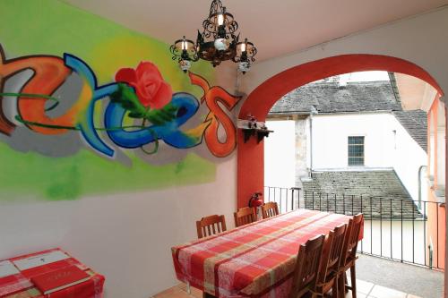 a dining room with a table and a colorful wall at Annie's Bed & Breakfast in Ascona