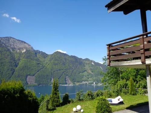 a bench with a view of a lake and mountains at Ferienhaus Chalet Sarah in Seelisberg
