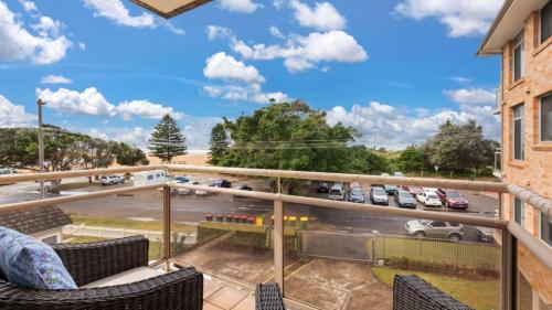 a balcony with chairs and a view of a parking lot at Seaview 5 - Great Beach Views in Avoca Beach