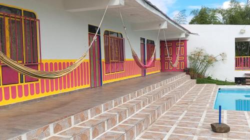 a house with a swimming pool in front of it at Finca El Turpial in Ulloa