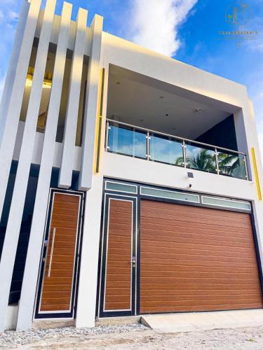 a house with two garage doors in front of it at Casa Greengo's Playa Matanchen in La Palma
