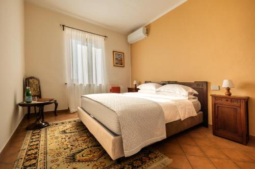 a bedroom with a large bed and a rug at Casa Nizza D'Oro in Castelnuovo