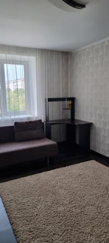 a living room with a couch and a window at Khmelnitsky in Zarechʼye