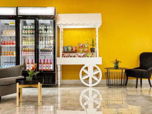 a store with a drink cart in a yellow room at ibis budget Sheffield Arena in Sheffield