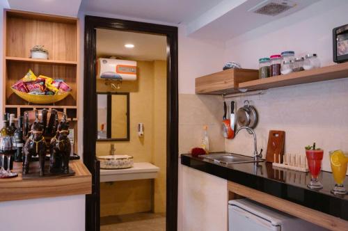 a kitchen with a sink and a counter top at SAM Hotel and Apartment in Da Nang