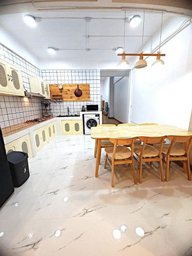 a large kitchen with a wooden table and chairs at A Day Home in Chiang Mai