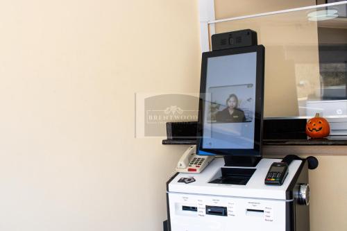 a computer monitor sitting on top of a printer at Brentwood inn & Suites - Lynchburg in Lynchburg