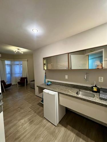 eine Küche mit Spüle und ein Wohnzimmer in der Unterkunft 1155 golden 55m2 1 quarto frente mar avenida beira mar in Fortaleza