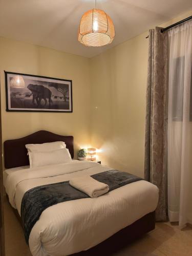 a bedroom with a large bed and a pendant light at Frost Homes in Eldoret