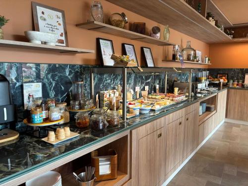 a buffet line with many different types of food at Novotel Suites Rouen Normandie in Rouen