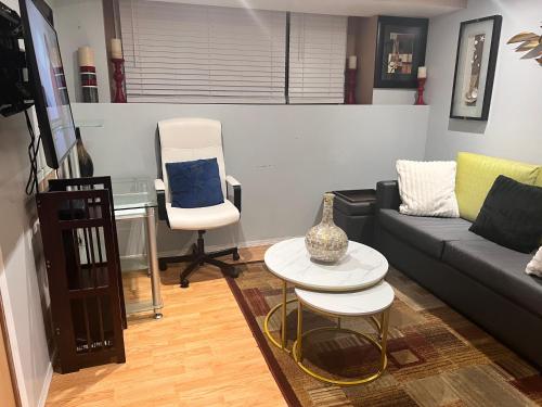 a living room with a couch and a table and a chair at Gull lake in Winnipeg