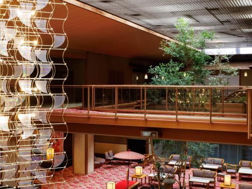 a lobby with a staircase and a wall with a building at Hamanoyu in Suwa