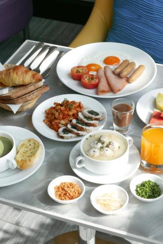 a tray with plates of food on a table at Le Tada Residence in Bangkok