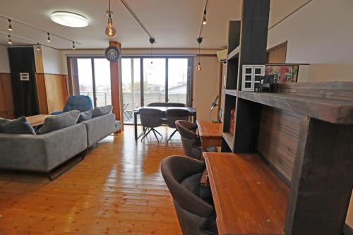 a living room with couches and a large fireplace at Laina Minoh Makiochi in Minoo