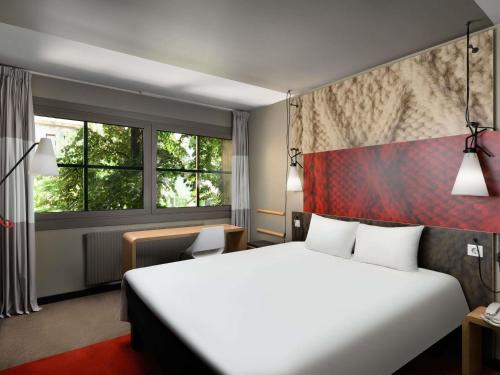 a hotel room with a large bed and a window at Ibis Budapest Heroes Square in Budapest