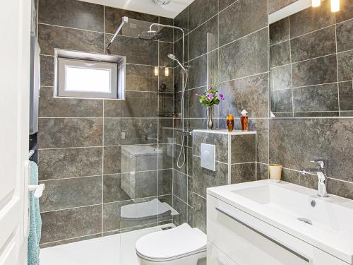 a bathroom with a shower and a toilet and a sink at Gîte de l'Argonne - FR-1-491-391 in Cheverny
