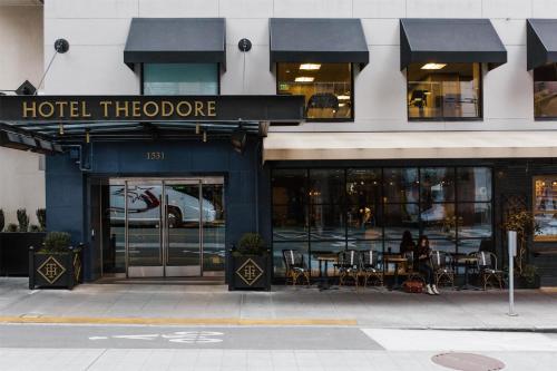 a hotel doorway with tables and chairs in a building at Hotel Theodore Seattle Downtown, Tapestry by Hilton in Seattle