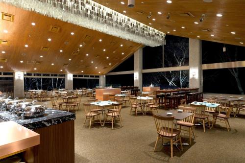 a large dining room with tables and chairs at The Green Leaf Niseko Village, Tapestry Collection by Hilton in Niseko