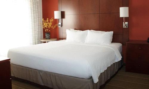 a large white bed in a hotel room at MainStay Suites Appleton Airport - Fox River Mall Area in Appleton