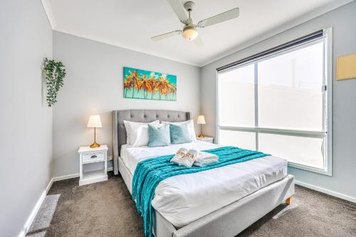 a bedroom with a bed and a large window at StayAU 4BR Family-Friendly Home near Deakin Uni in Whittington