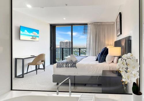 a bedroom with a king sized bed and a desk at Oceanview Luxury Escape Oracle Tower 2 Level 24 in Gold Coast