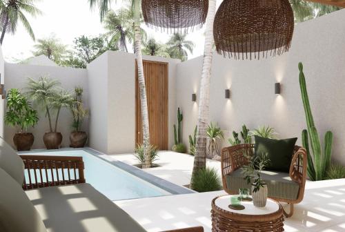 a patio with a swimming pool and palm trees at New Luxury Ribamar Villas in Uluwatu