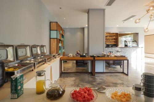a restaurant with a long table with fruit on it at Yangshuo Courtyard Hotel - An all-English team by the Li River in Yangshuo