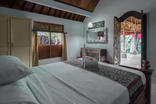 Ένα ή περισσότερα κρεβάτια σε δωμάτιο στο Nuaja Balinese Guest House