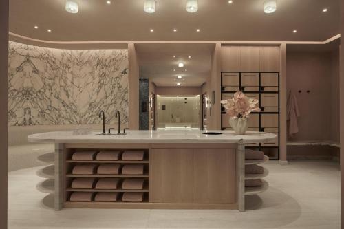 a bathroom with a counter with a sink and a sink at Conrad Athens The Ilisian in Athens