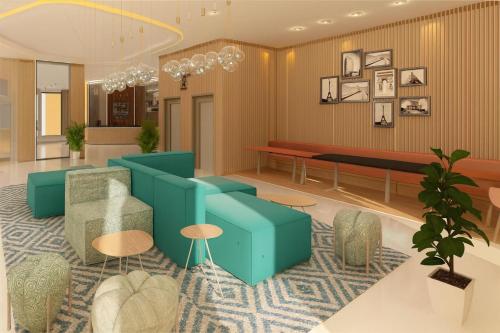 - un hall avec un canapé bleu et des chaises dans l'établissement Hampton By Hilton Ben Guerir, à Benguerir