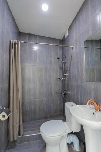 a bathroom with a toilet and a sink at Tato in Tbilisi City