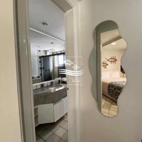 a bathroom with a sink and a mirror at Jatiúca Suítes Resort - Flat 413 in Maceió