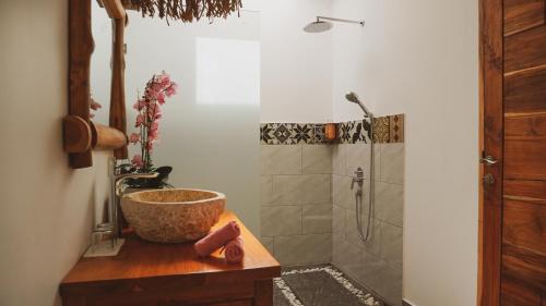 a bathroom with a sink and a shower at Angsoka Villas Amed in Amed