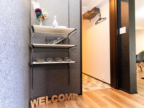 a room with a black wall with shelves at Rino-Haku 01 in Anan